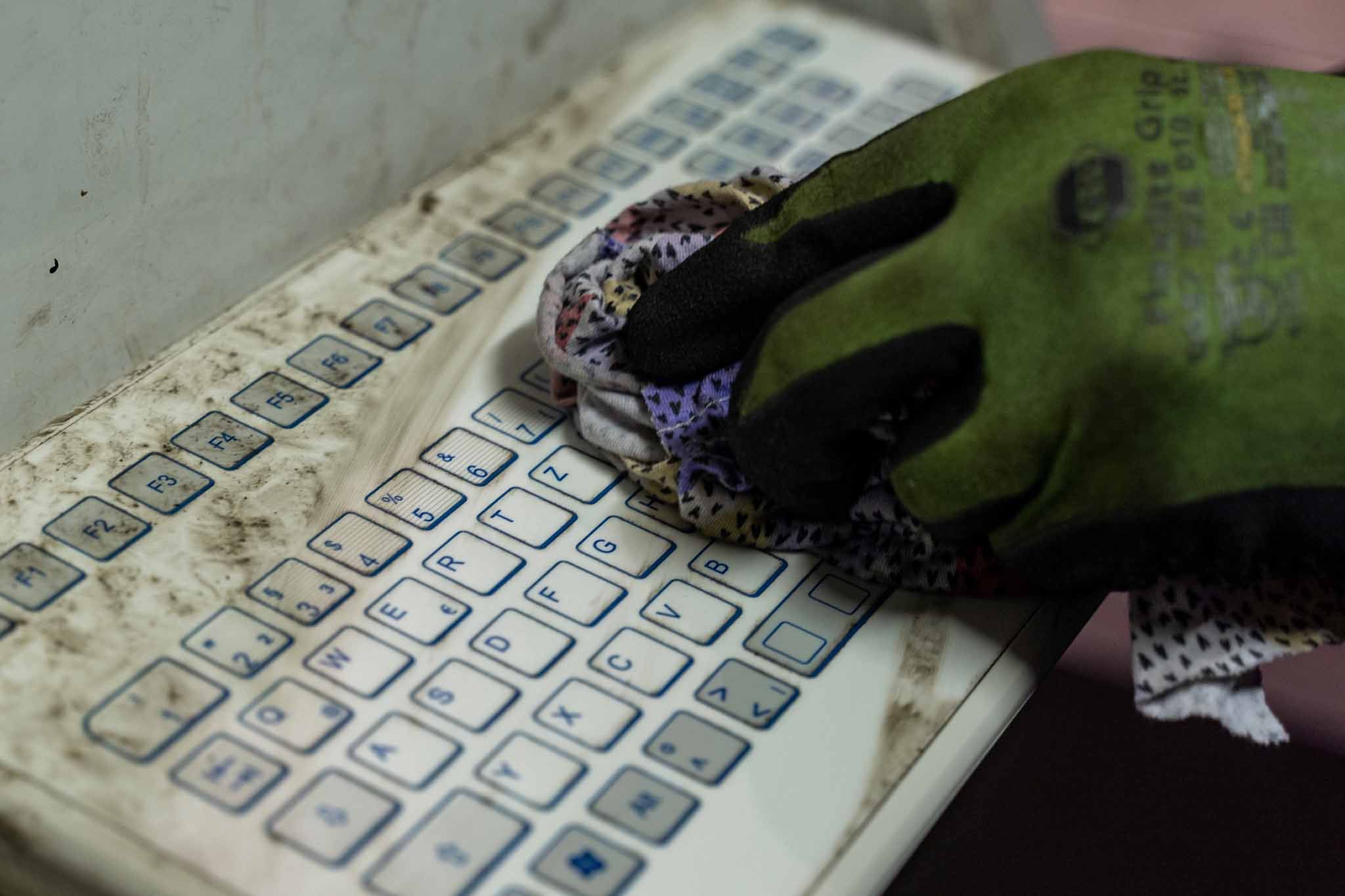 dirty foil covered industry keyboard being cleaned