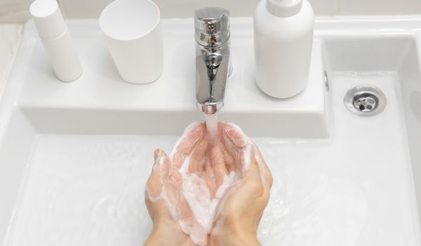 man demonstrates hand hygiene